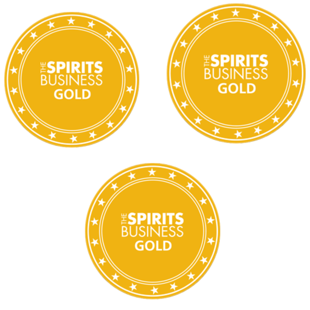 A photo of three gold badges on a white background. The badges have the text