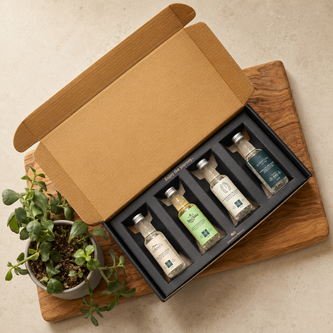 Set of small bottles in a box on a wooden board with a plant beside it